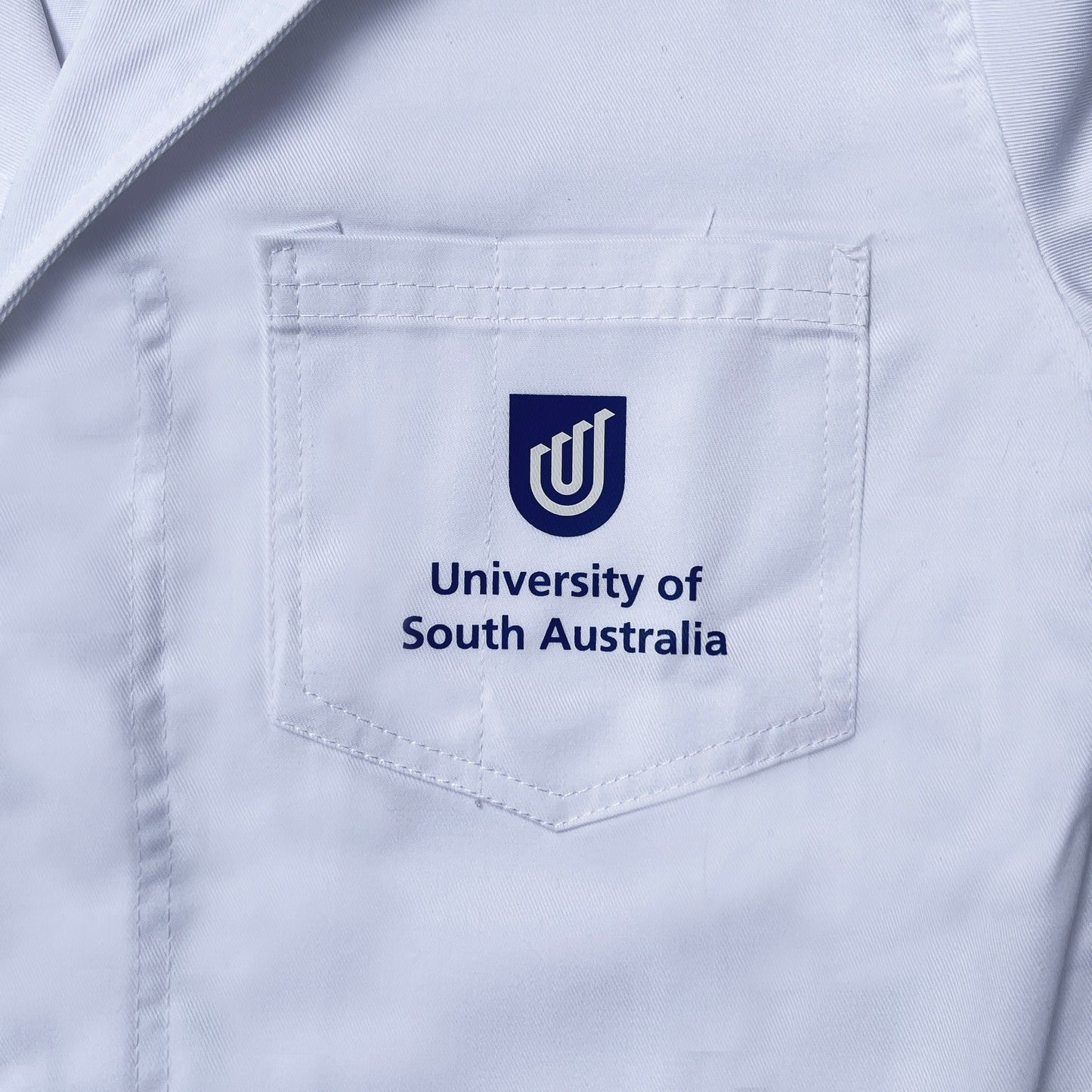 Lab Coat with UniSA logo.
